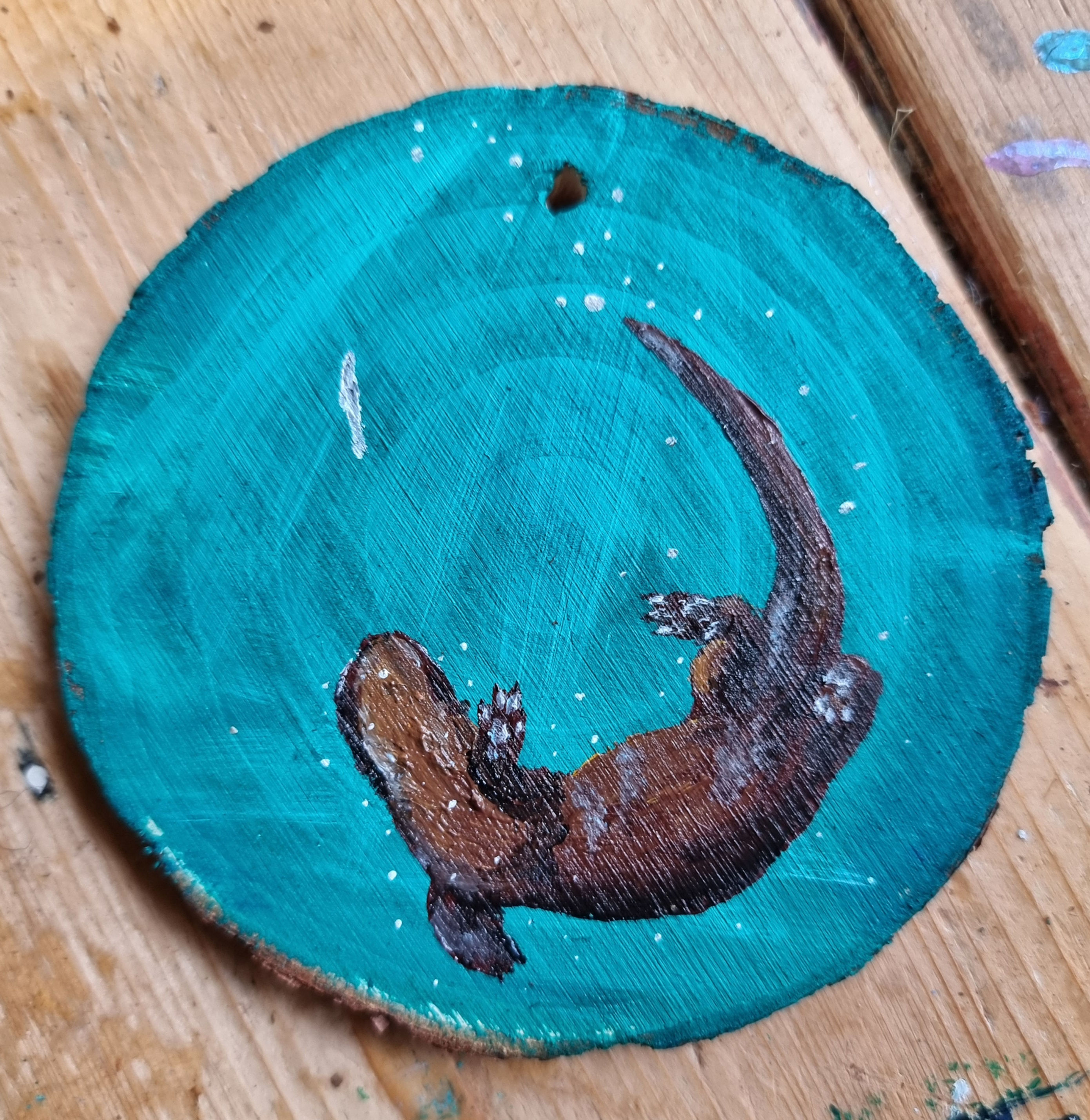 Otter on wood slice