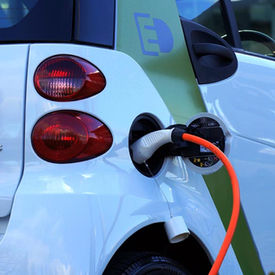 Electric vehicles displayed at an automotive facility as Indian automakers partner with Chinese technology providers for EV development.