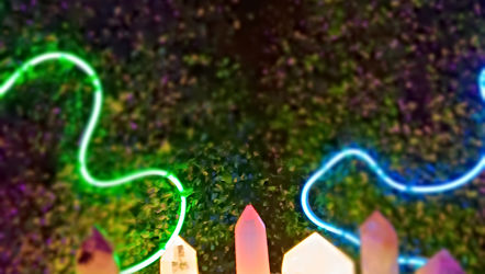 Glowing crystals with neon squiggle lights arranged as a ritual offering in electric altar setup