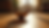 Eye-level view of a crystal singing bowl resting on a wooden floor in a softly lit room