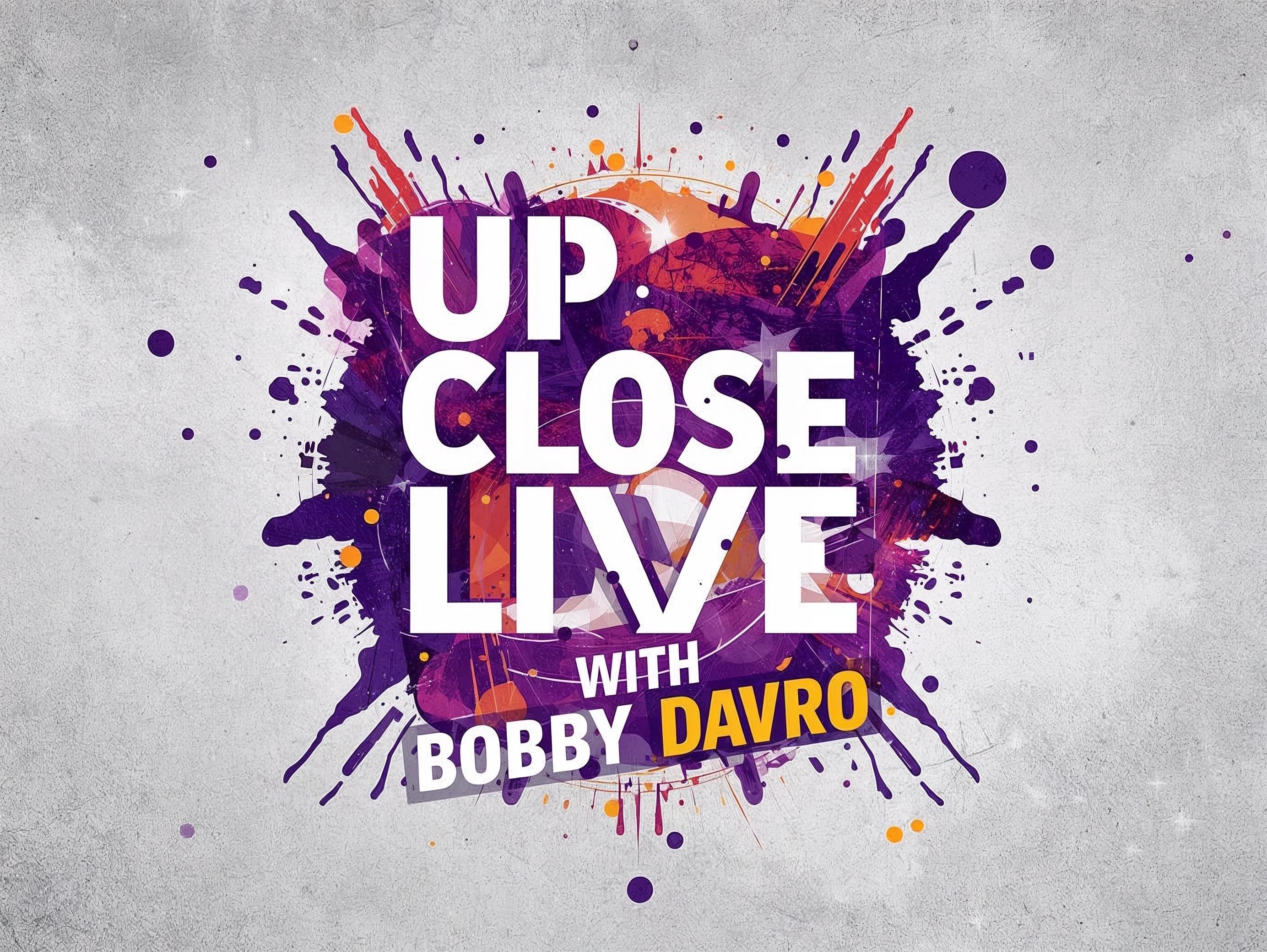 Legendary comedian Bobby Davro performing live on stage with a spotlight.