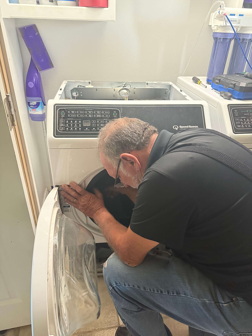 Appliance technician fixing a washer in Tulsa