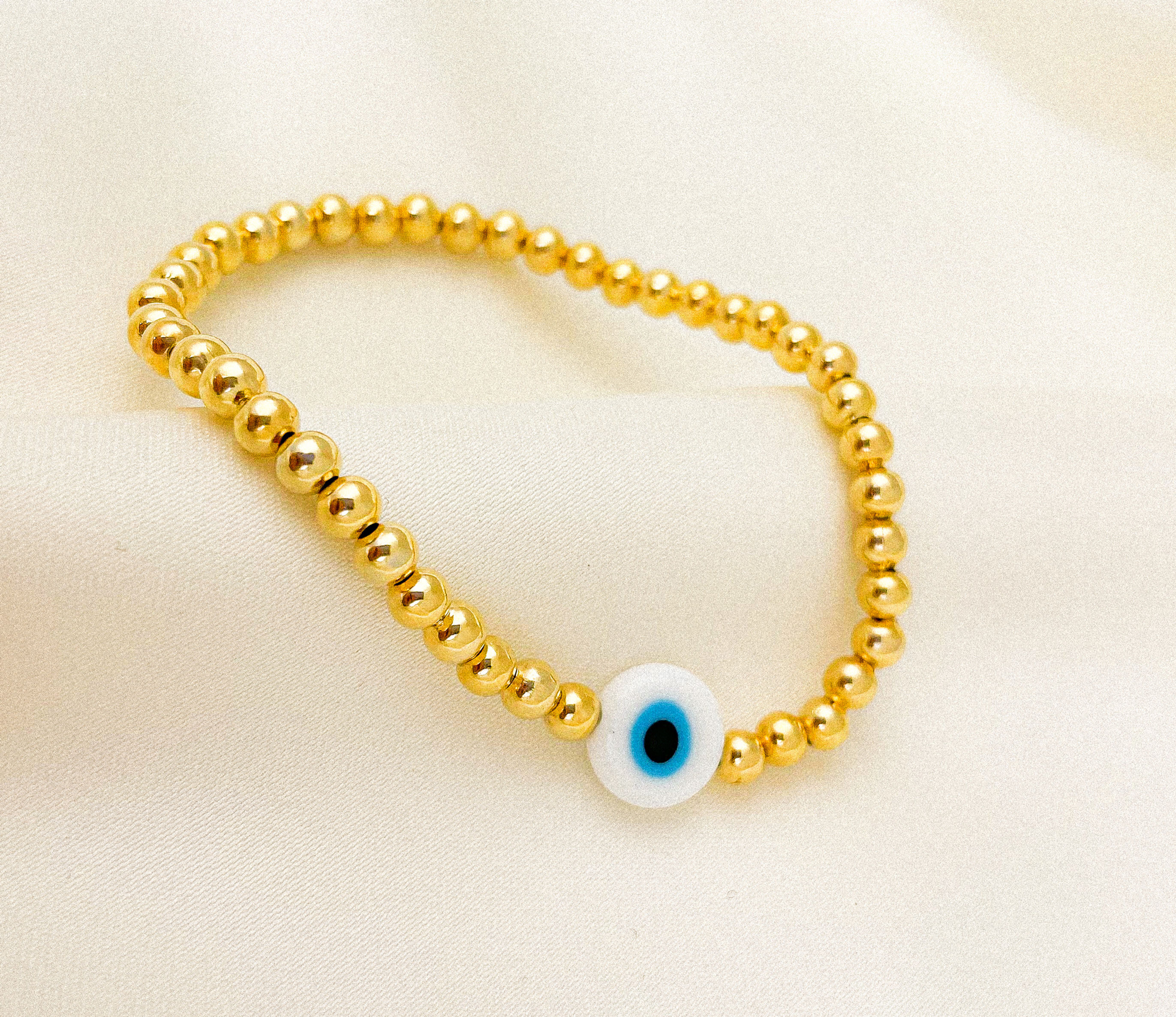 PULSERA ESFERAS Y OJO / ORO LAMINADO