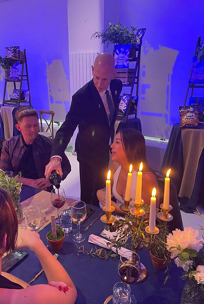 Image of Sommelier pouring wine at a party