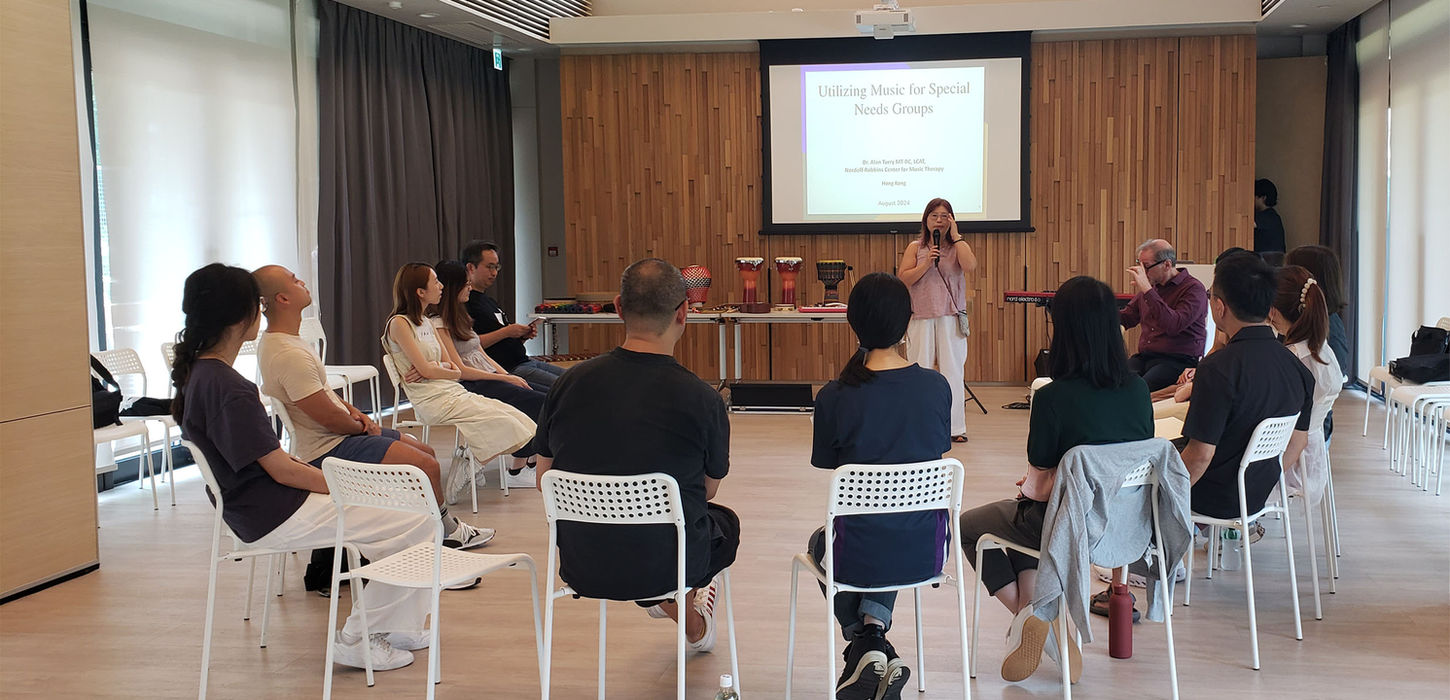 people sitting in a circle listening our educator with a slide projected on a screen