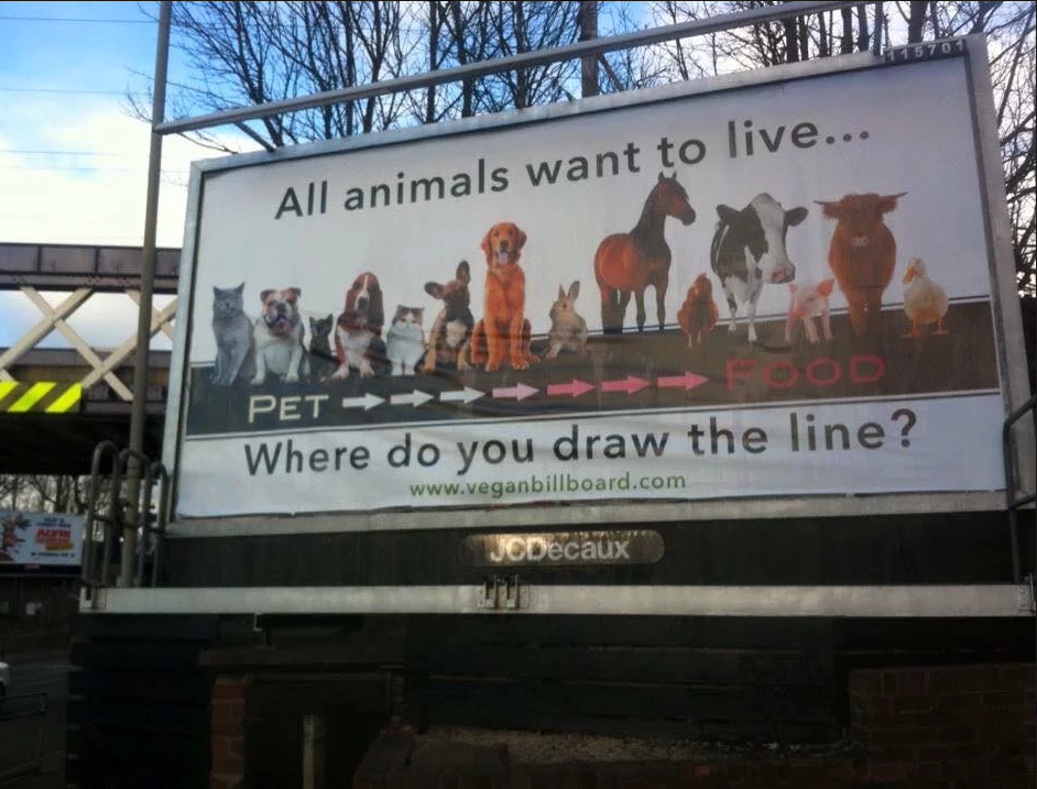 billboard featuring line of animals-'all animals want to live...where do you draw the line?'