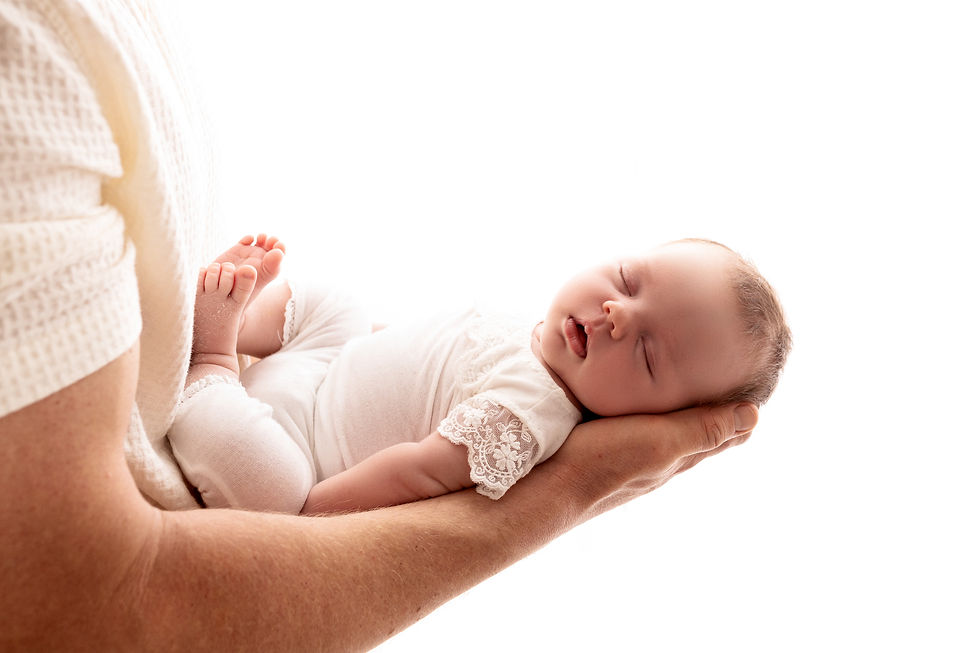 Newborn baby sleeping in Daddy's arms