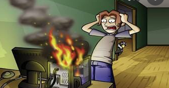 a guy watching his computer go up in smoke and flames