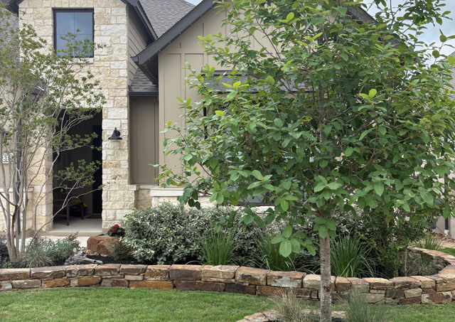 Clean landscape edging with Texas blend river rock beds Boerne TX
