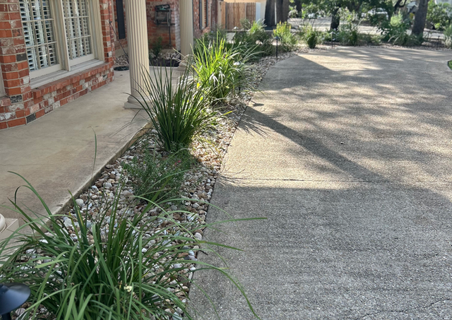 Castle Hills backyard landscape renovation with outdoor kitchen, fire pit, and Belgard paver patio.