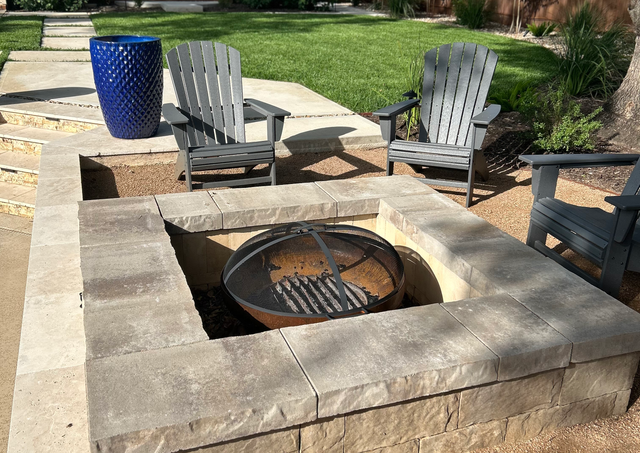 Custom fire pit with Belgard wall block and fire brick lining in Castle Hills backyard.