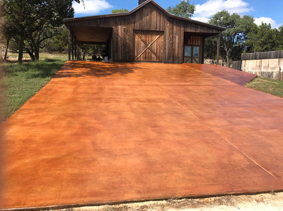San Antonio terracotta stained concrete court beside a barn