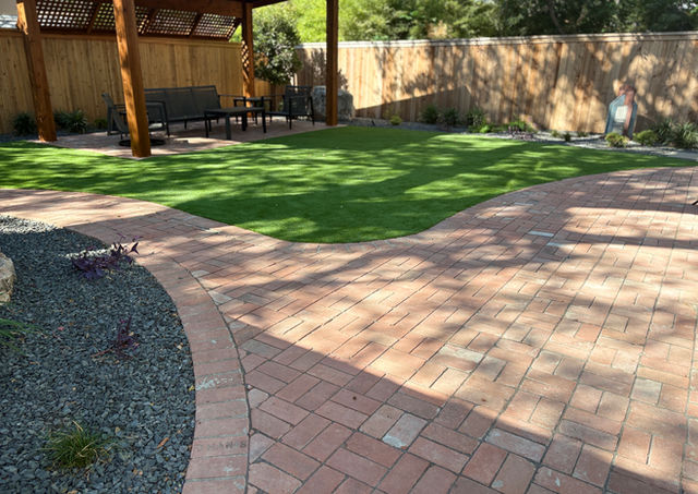 Artificial turf play area for children in family-friendly low-maintenance San Antonio backyard.