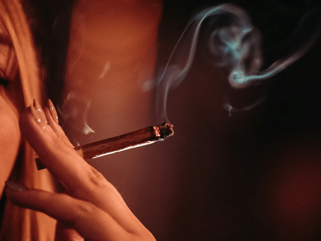 A woman holding a cigar.