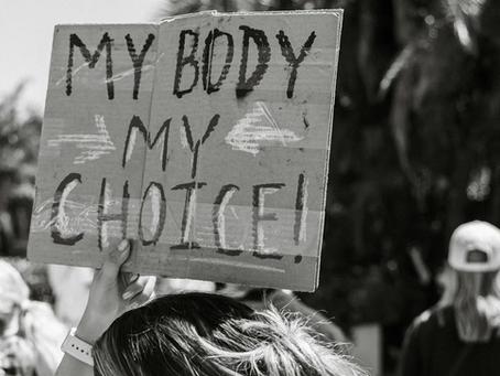 A hand holding a sign at a protest.