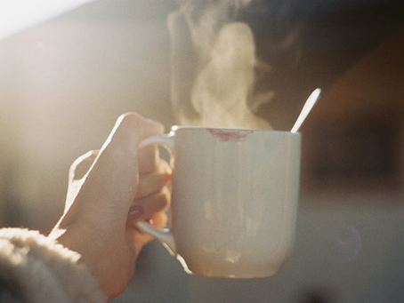 A hand holding a cup of coffee.