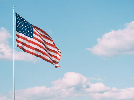 An American flag blowing in the wind.