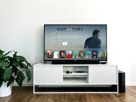 A TV in front of a white wall.