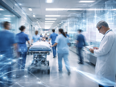 Doctors rush a patient on a stretcher through a busy hospital corridor. A doctor reads a tablet. Blue hues convey urgency and technology.