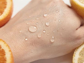 Water droplets on a hand surrounded by fresh lemon and orange slices, conveying a fresh and hydrating mood against a neutral background.