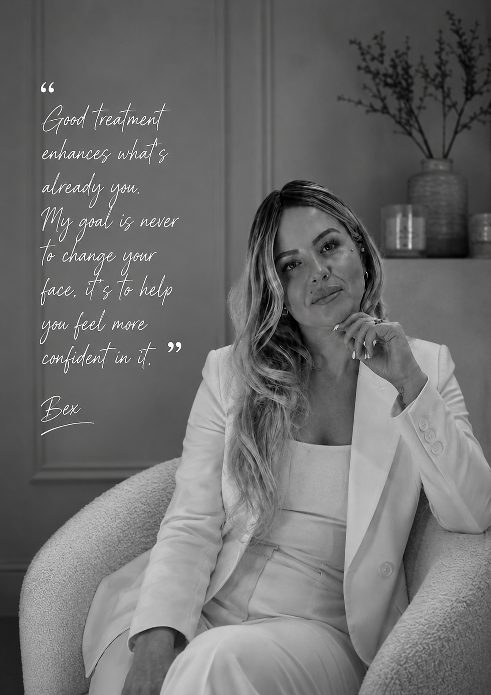 Woman in white suit sits thoughtfully in an armchair. Text beside her reads: "Good treatment enhances what's already you." Bex.