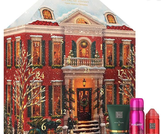 Advent calendar shaped like a snowy townhouse, with numbered doors and three Rituals gift products at bottom right.