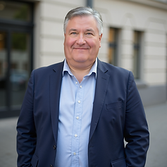 Christopher Painter standing outside a concert hall, wearing a dark blue jacket and a light blue shirt