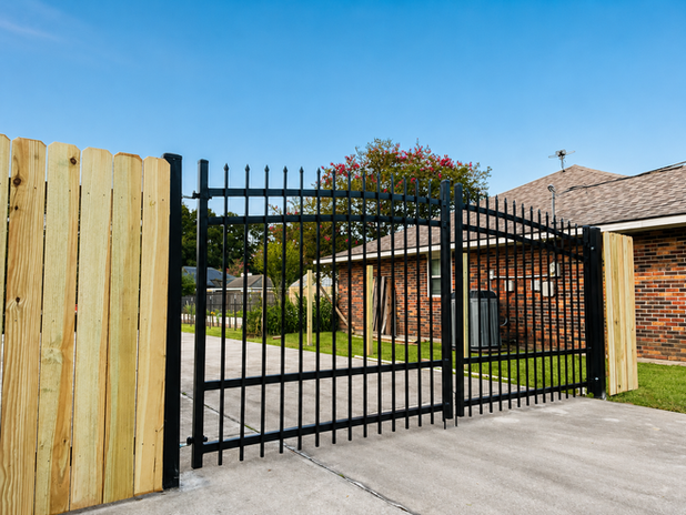 Angled view of The Double Arched black metal gate