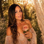 dani dinvine love holding a rose