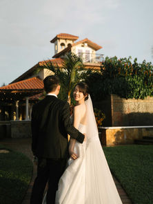 Villa Toscana Miami wedding ceremony with soft floral design, greenery, and romantic evening lighting