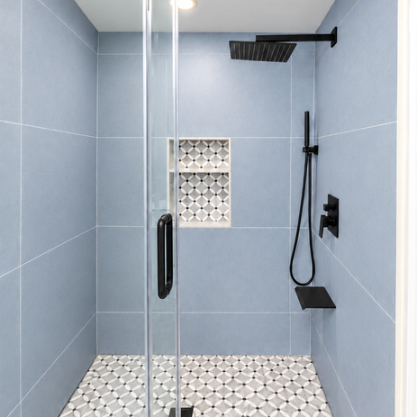 Custom tub-to-shower conversion with matte wall tiles and mosaic tile accents