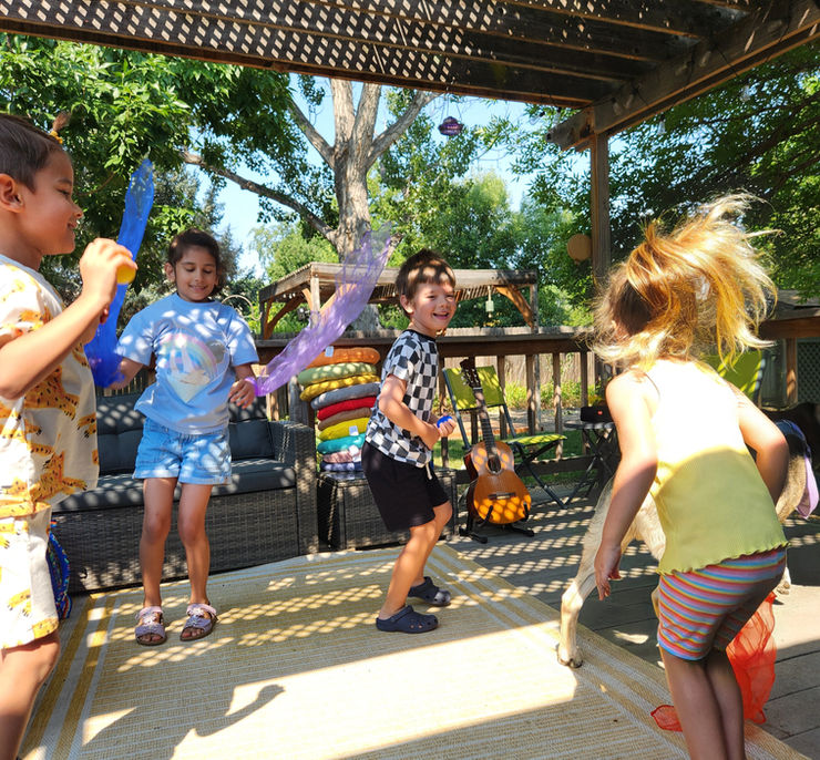 Enthusiastic kids playing musical instruments at an outdoor community park gathering.