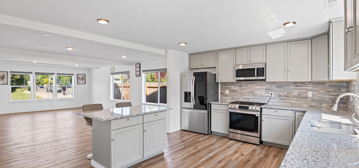 Modern kitchen with stainless steel appliances and granite countertops; HOME
