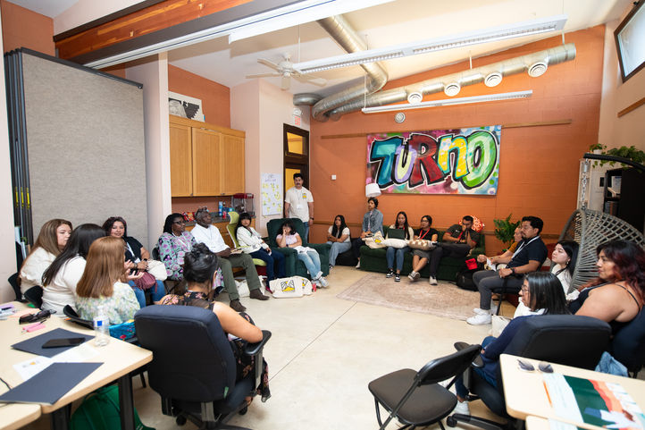 Group of people at a TURNO meeting in an office setting discussing ideas