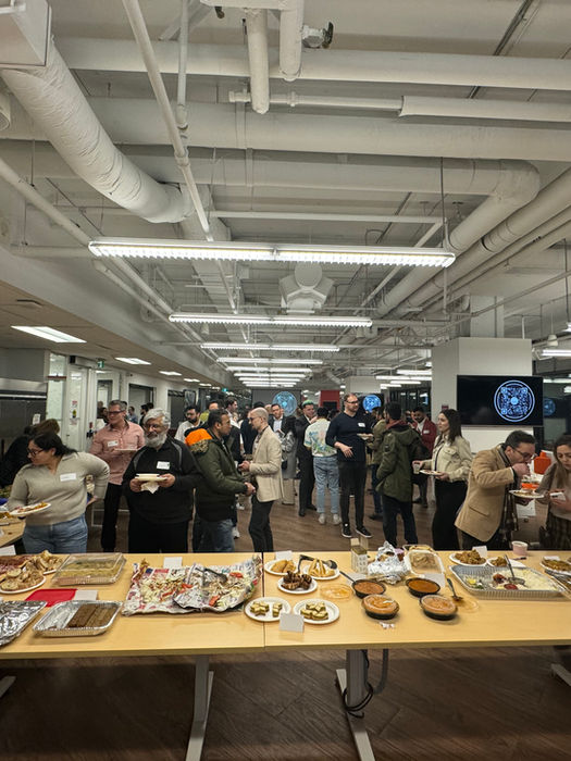 Table full of food from all over the world at the PORCH Potluck