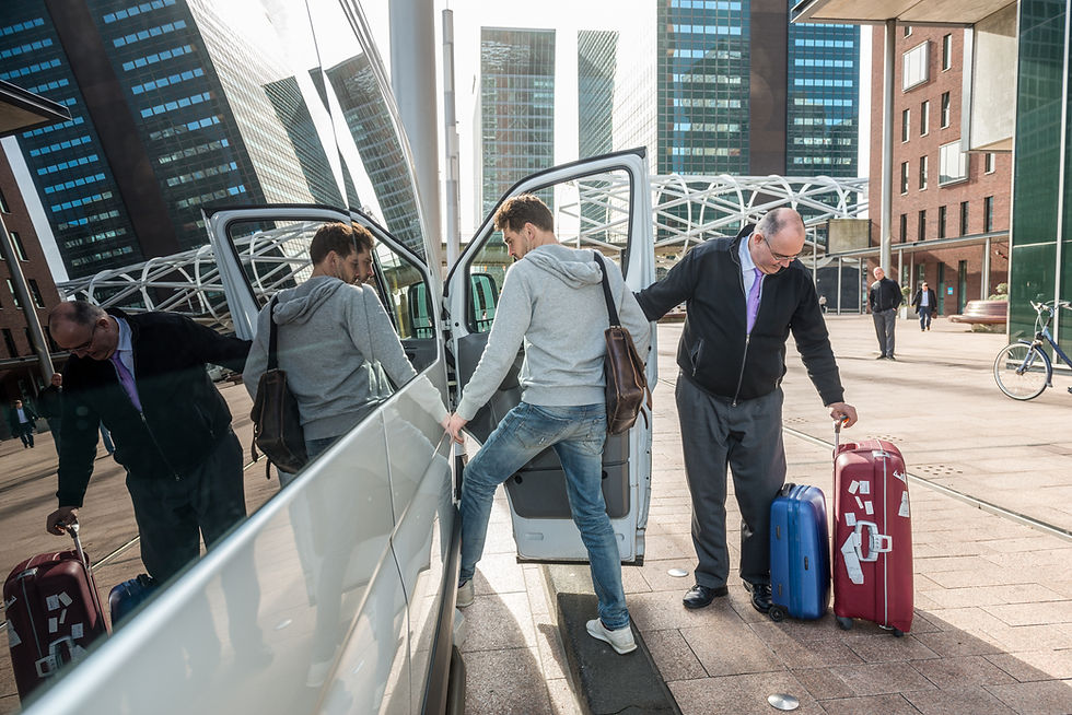 Taxi driver with luggage picking up male passenger at airport in city.jpg