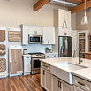 Interior of a modern home design center featuring a wide selection of custom cabinets, flooring samples, and tile displays for home customization.