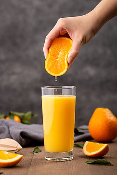 glass-orange-juice-person-squeezing-orange-it.jpg