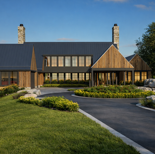 Architect-designed modern rustic farmhouse with black metal roof, vertical cedar cladding, twin stone chimneys, deep overhang entry porch, panoramic window wall, sweeping asphalt drive, and curated native plantings with granite boulder accents