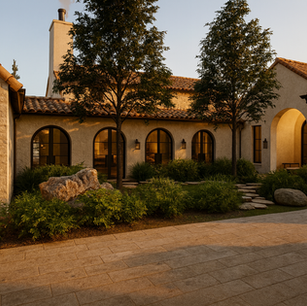 Spanish-style courtyard with arched windows, terracotta roof, and drought-tolerant planting—biophilic outdoor living courtyard