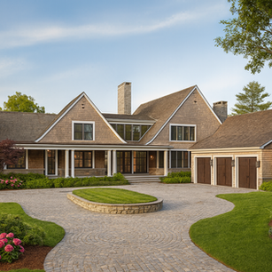 Shingle style motor court with circular driveway, multiple gables, and carriage-house garage doors