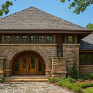 Prairie-style residence entry featuring a broad stone archway, low-pitched roof, and layered masonry detailing. The image emphasizes horizontal proportions, warm natural materials, recessed windows, and a grounded entry sequence that reflects craftsmanship and connection to the surrounding landscape.