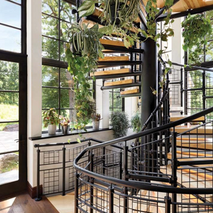 Architecture firm architect luxury residential design interior enduring artistry creative architecture stairs staircase stairway circular staircase spiral stairs custom industrial style railing irrigation system Biophilic design irrigated watering system atrium greenhouse indoor garden boxelder wood recycled materials MN home for sale
