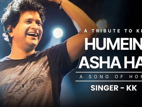 A monochrome portrait of singer KK with a soft spotlight highlighting his calm expression, surrounded by musical notes fading into the background. The text overlay reads “Humein Asha Hai – KK’s Final Song” with the MAJ Medias logo below. The image evokes emotion, nostalgia, and reverence
