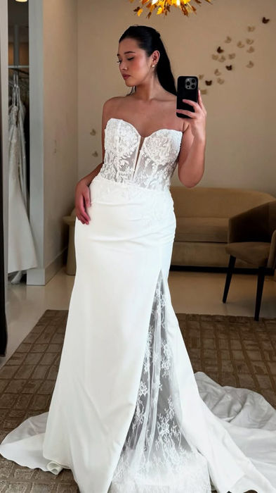 Bride in Eddy K Fit-n-Flare gown with beaded ivory lace and sequins over chantilly lace, cat-eye neckline, skin unlined bodice, crepe skirt, chantilly lace lined slit.