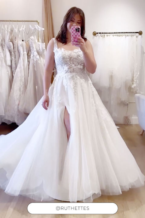 Eddy K a-line wedding dress with 3D appliques and tulle on woman taking a picture on the mirror