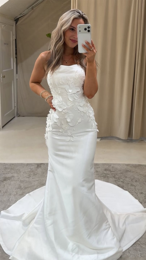 Blonde Bride wearing Fit-n-flare pearl ivory mikado wedding gown with delicate beaded 3D appliqués, corset skin unlined back, buttons to end of train.