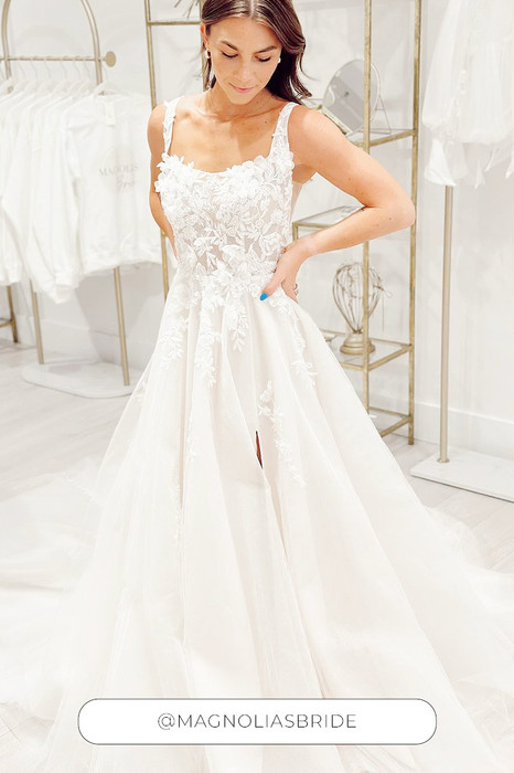 Eddy K a-line wedding dress with 3D appliques and tulle on woman with hands on her waist