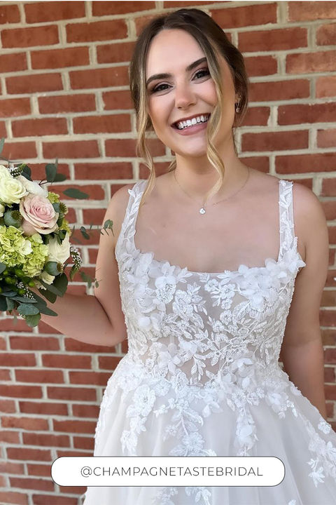 Eddy K a-line wedding dress with 3D appliques and tulle on woman taking a picture on the mirror