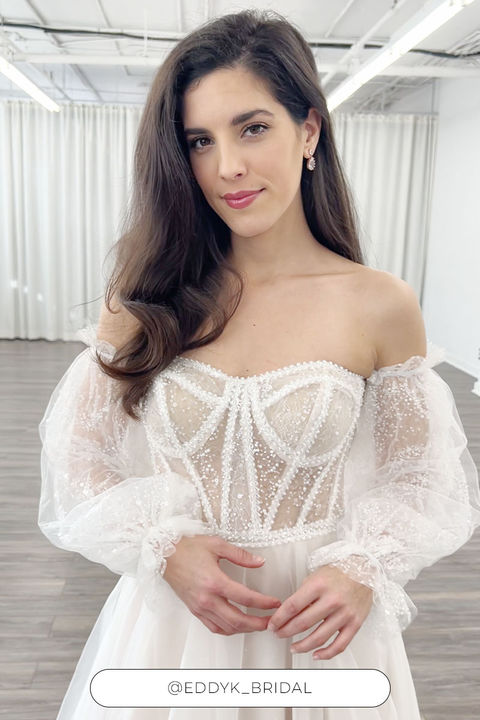 Woman wearing sparkly ballgown with detachable sleeves